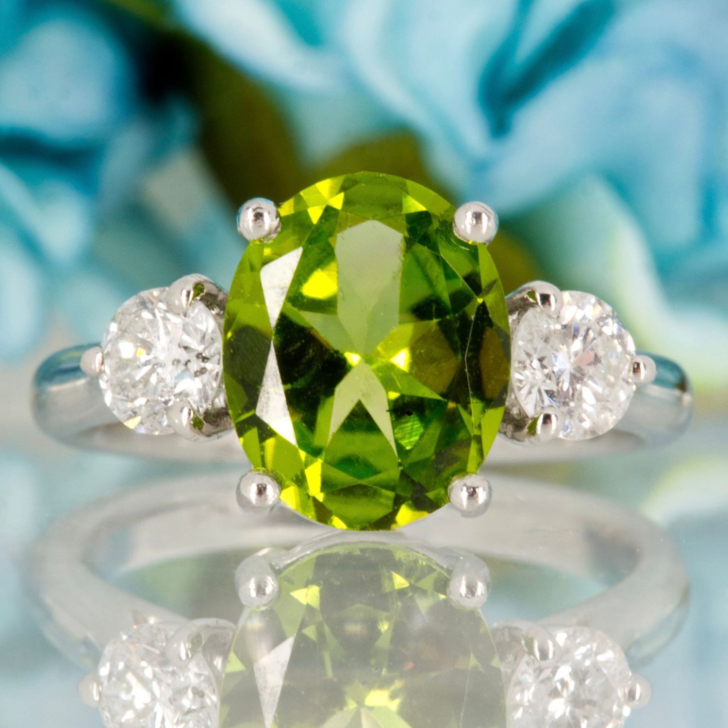 Platinum Oval Cut Peridot & Round Brilliant Cut Diamond Trilogy Ring Platinum Oval Cut Peridot & Round Brilliant Cut Diamond Trilogy Ring