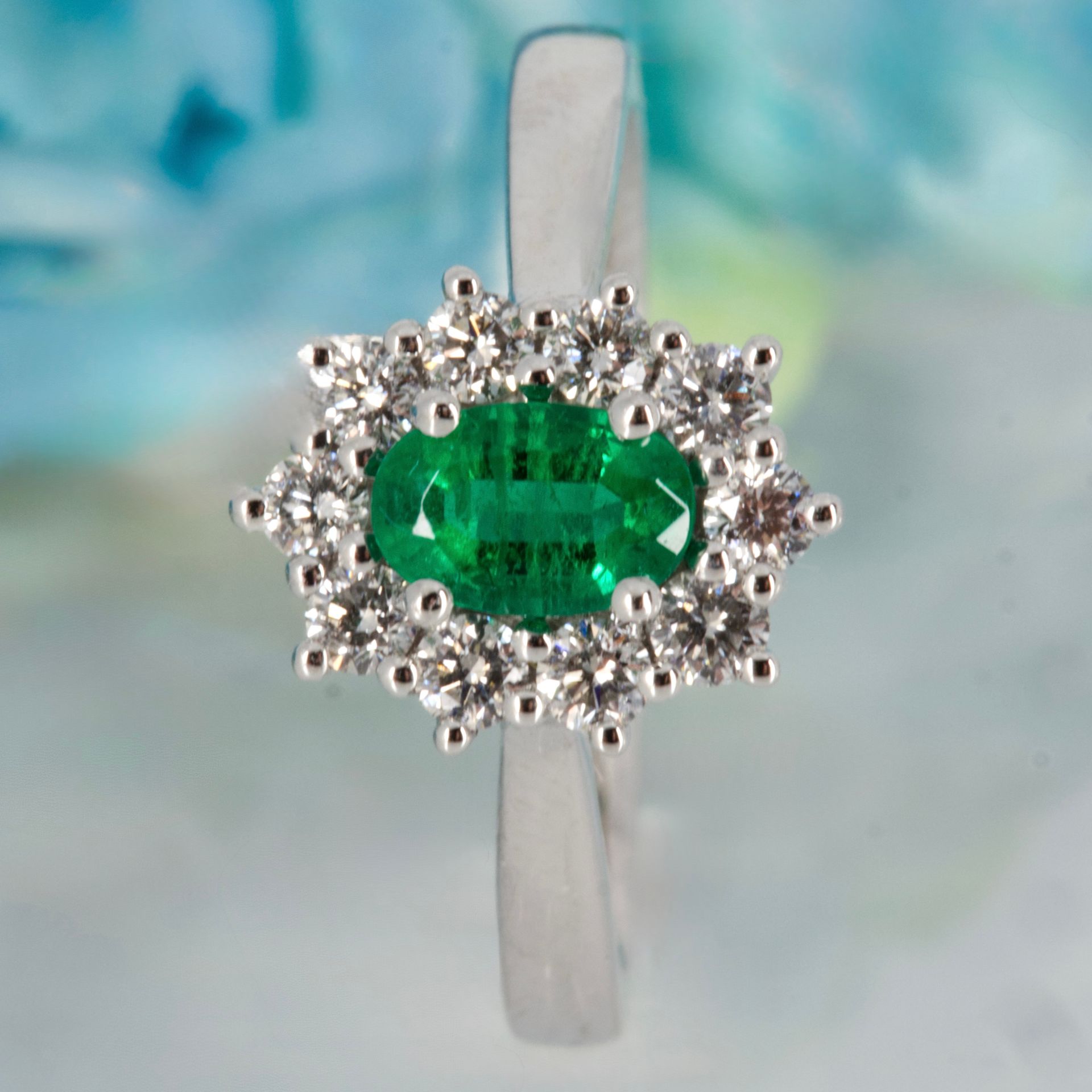 Platinum Oval Cut Emerald & Round Brilliant Cut Diamond Cluster Ring