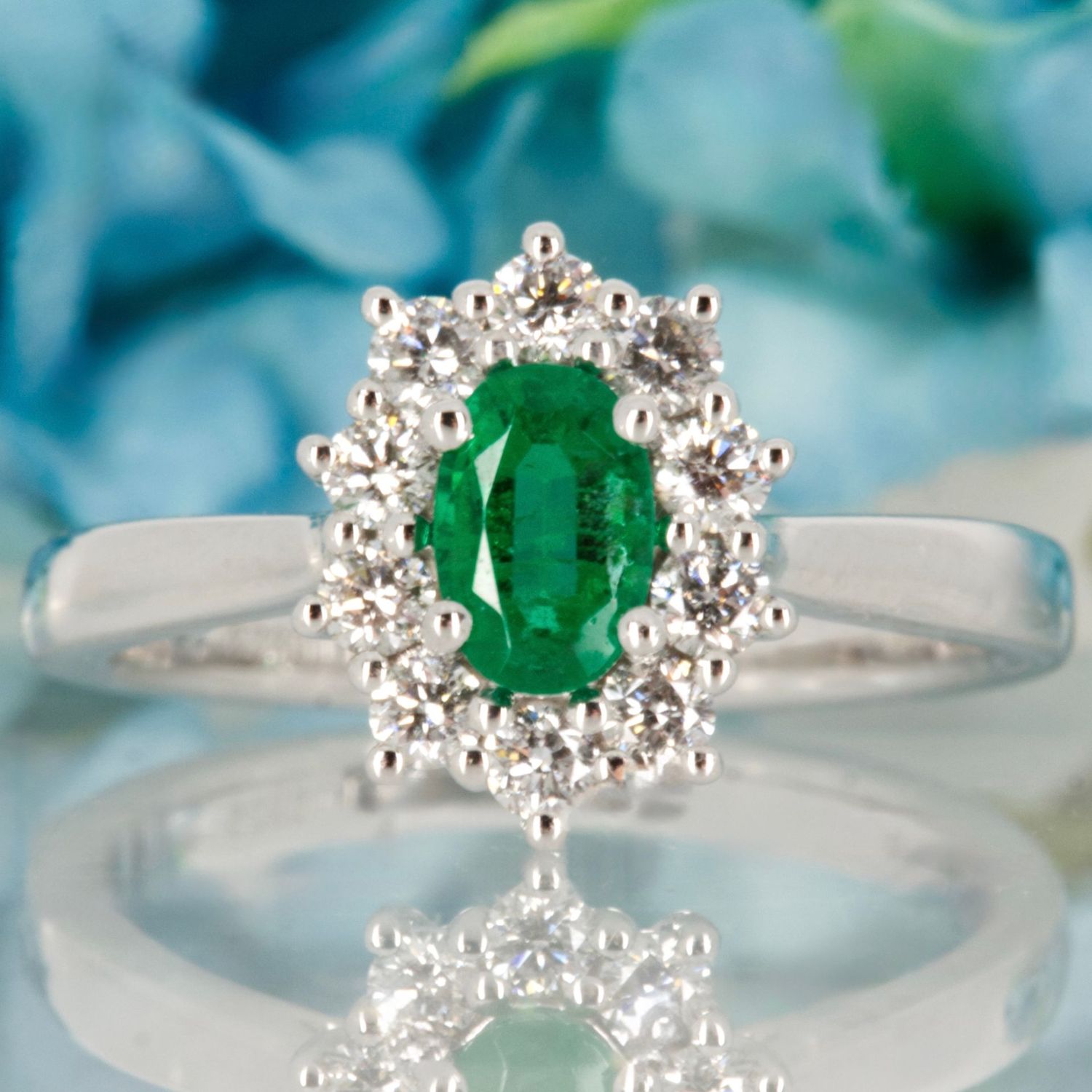 Platinum Oval Cut Emerald & Round Brilliant Cut Diamond Cluster Ring