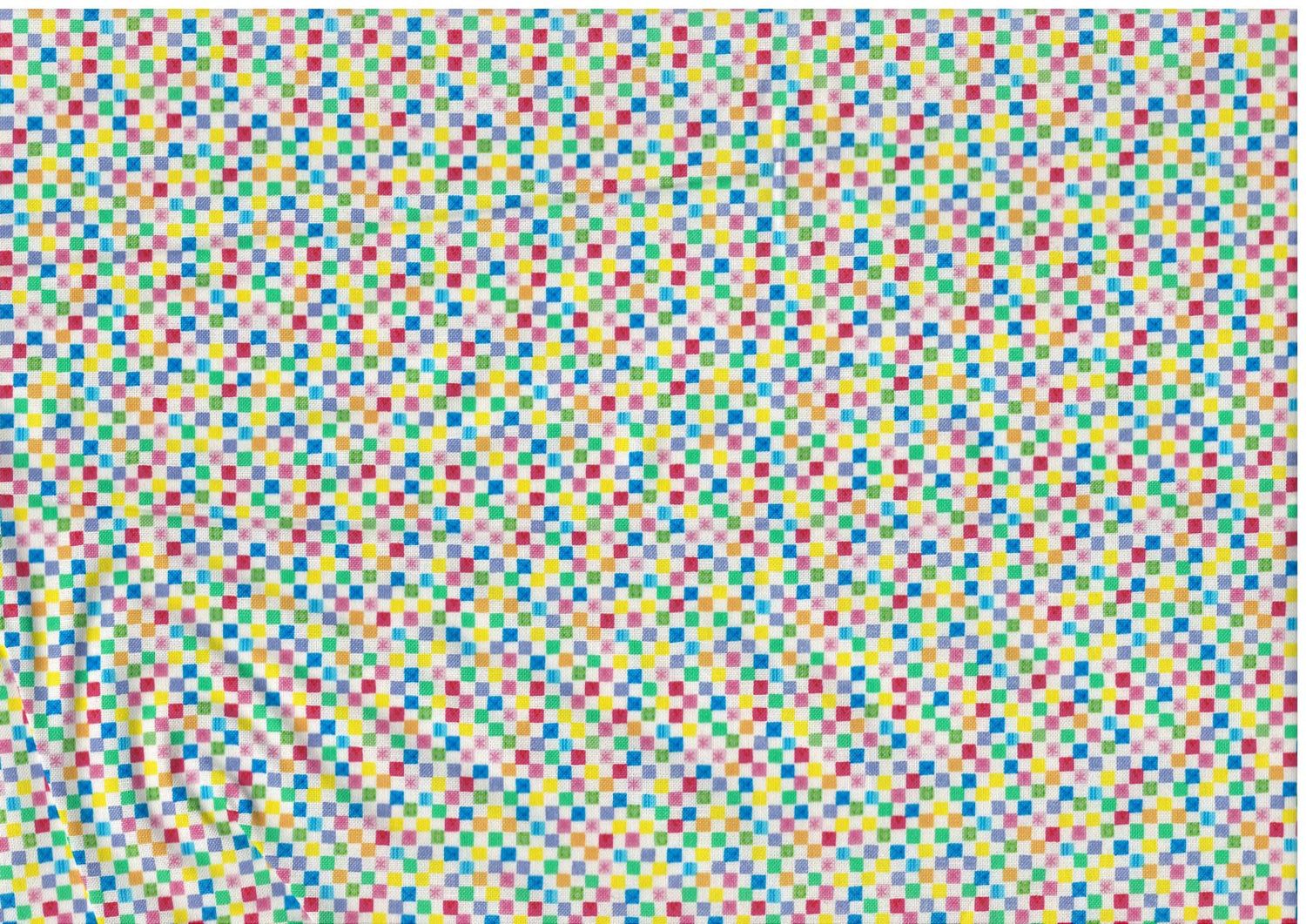 Bomullstyg med små färgglada kvadrater – patchworktyg för lappteknik.