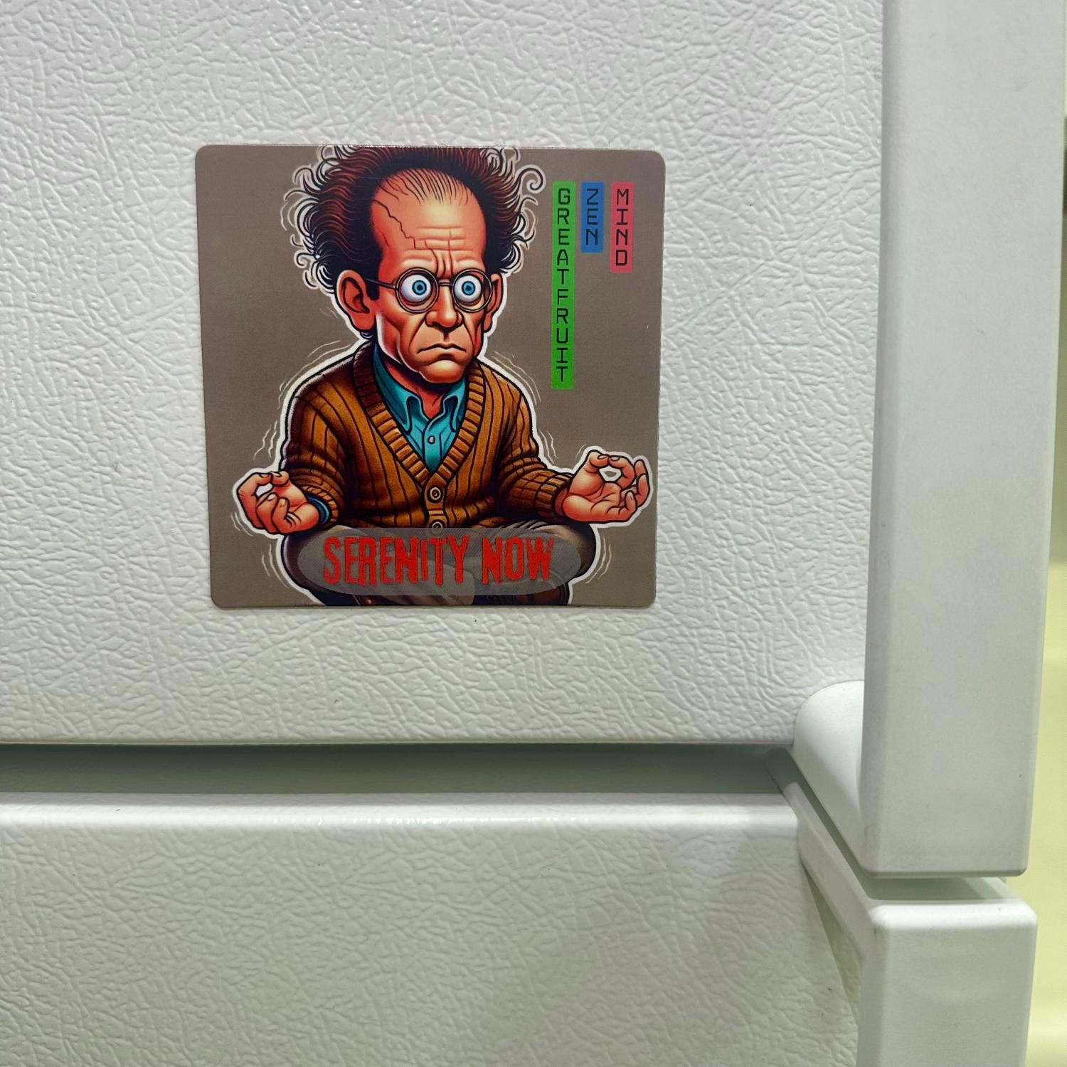 Large Magnet—Serenity Now Large Serenity now magnet featuring a stressed, eye-popping meditating man stuck next to a refrigerator handle.