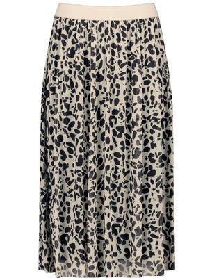 Woman In Gold Seashell Patterned Skirt