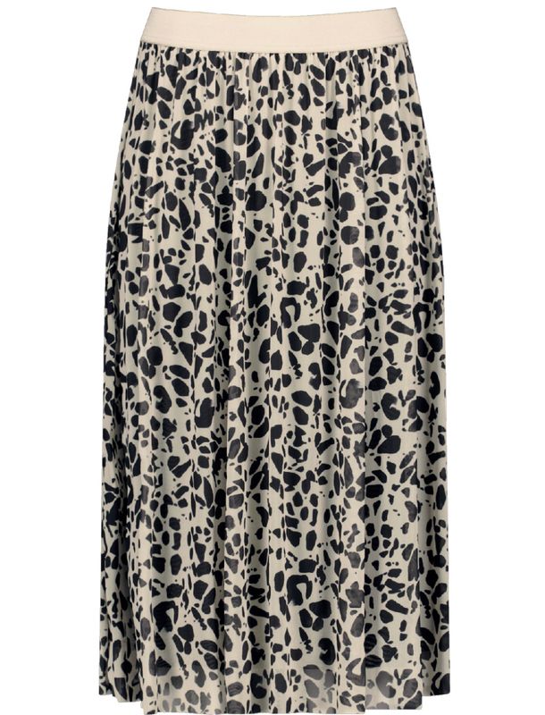 Woman In Gold Seashell Patterned Skirt