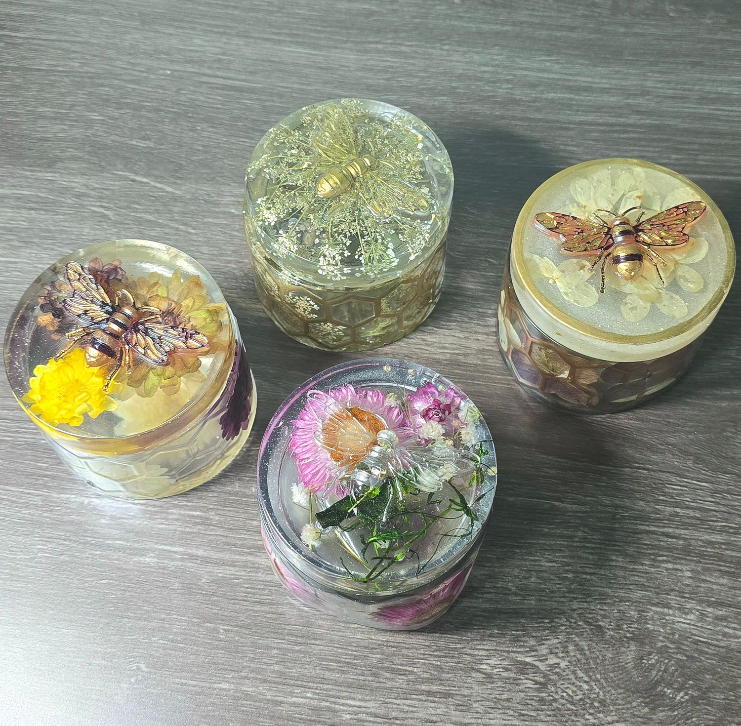 Handmade resin keepsake jar with dried flowers and gold bee lid