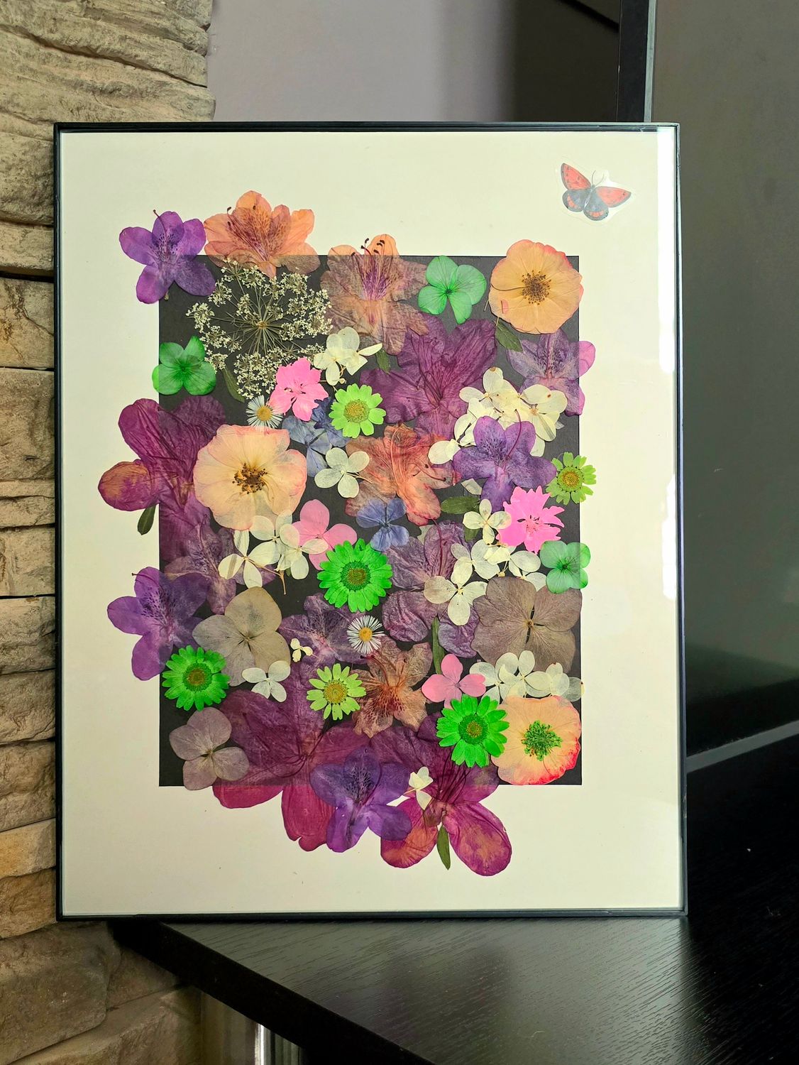 Framed 11x14 pressed flower artwork with colorful blooms on black background