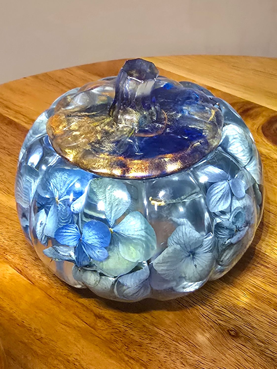Epoxy resin pumpkin jar with dried flowers inside. 