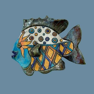 Raku fish on a blue card by Annabel Langrish