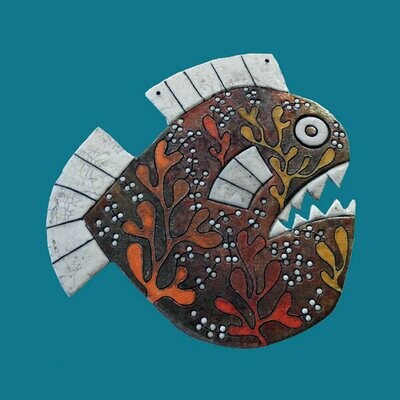 Raku seaweed fish on a blue card by Annabel Langrish
