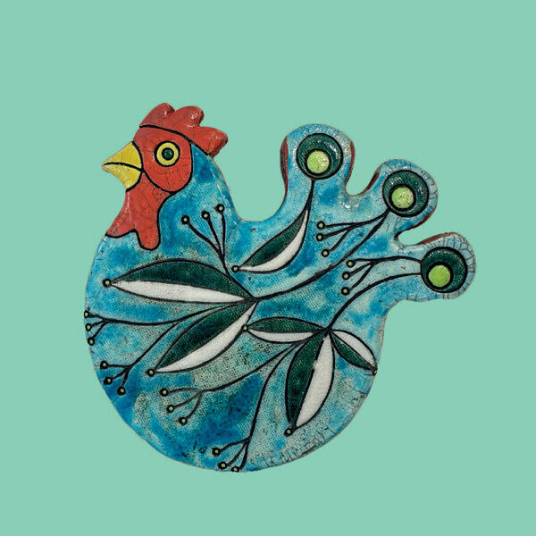 Raku chicken on a green card by Annabel Langrish