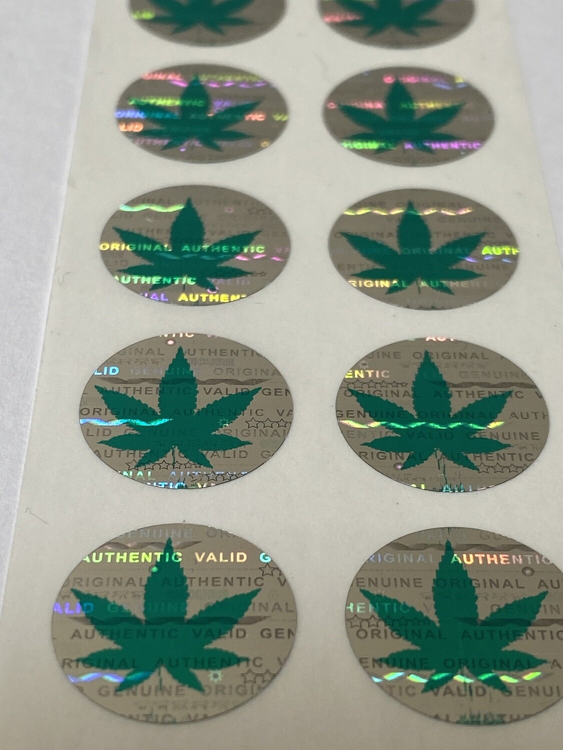 .625 inch round tamper evident hologram label w/ cannabis symbol