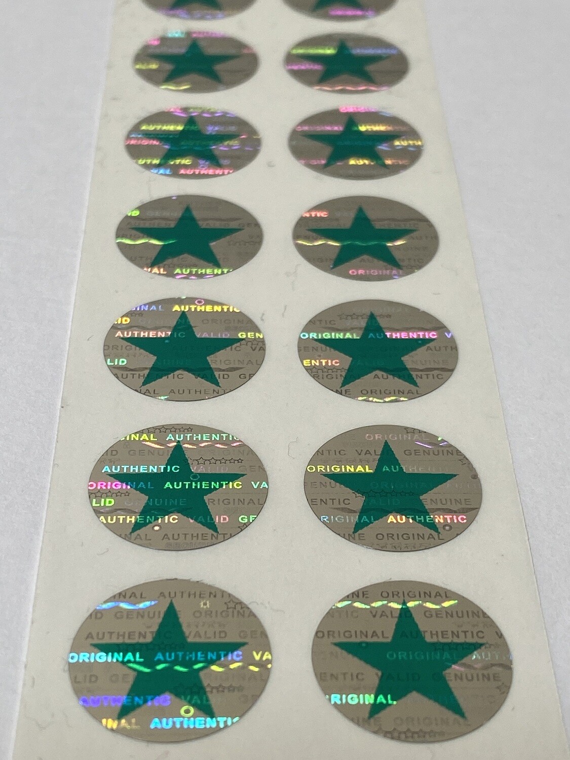 .625 inch round tamper evident hologram label w/ green star