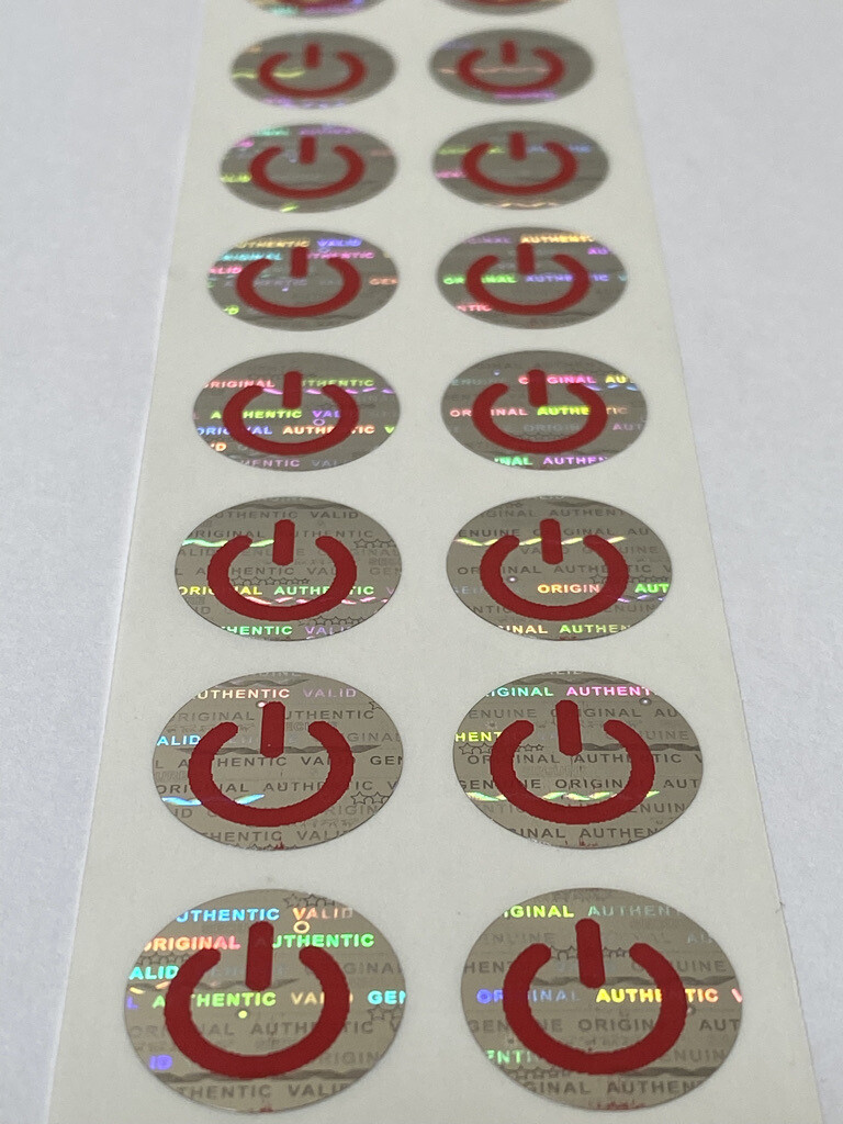 .625 inch round tamper evident hologram label w/ on symbol