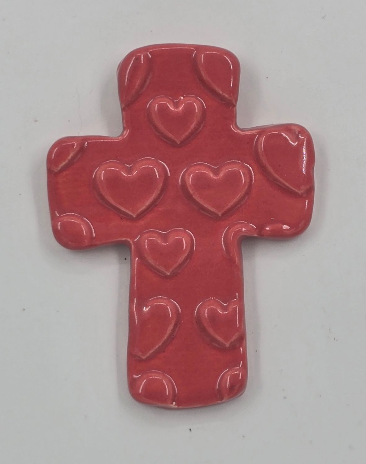 Pink cross with heart pattern
