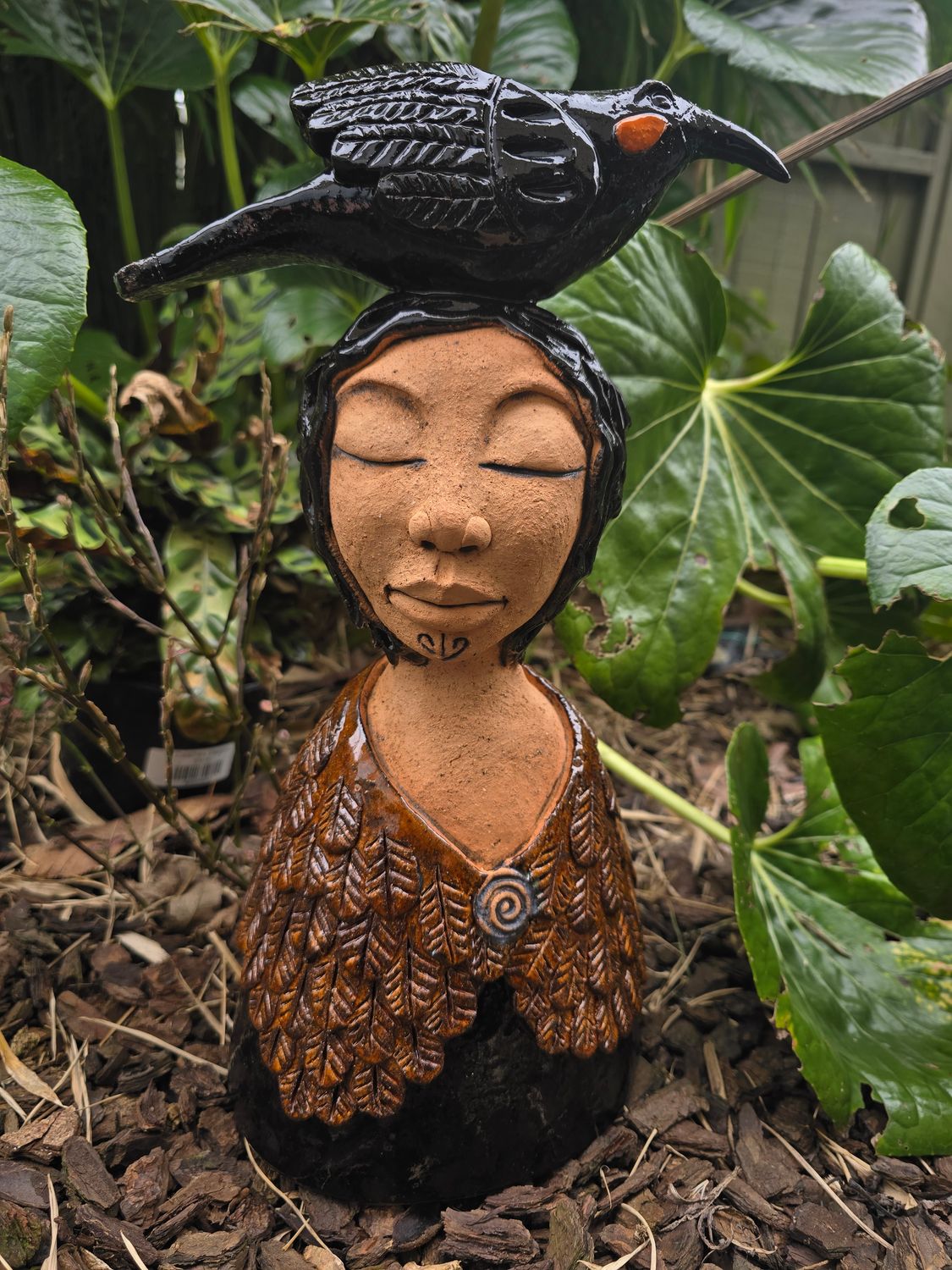 Brown cloaked lady with Huia