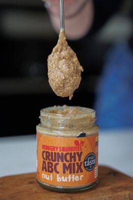 Close-up of a spoonful of Crunchy ABC Mix nut butter being lifted from the jar – highlighting rich texture and crunch.