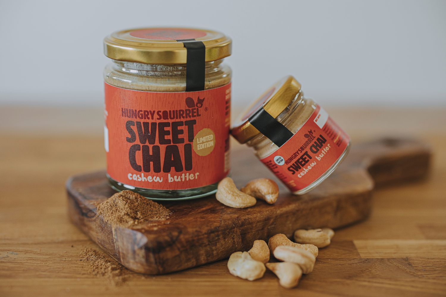 180g &amp; 40g Jar of Sweet Chai Cashew Butter with gold lid and vibrant orange label – limited edition seasonal nut butter.
