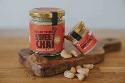 180g &amp; 40g Jar of Sweet Chai Cashew Butter with gold lid and vibrant orange label – limited edition seasonal nut butter.
