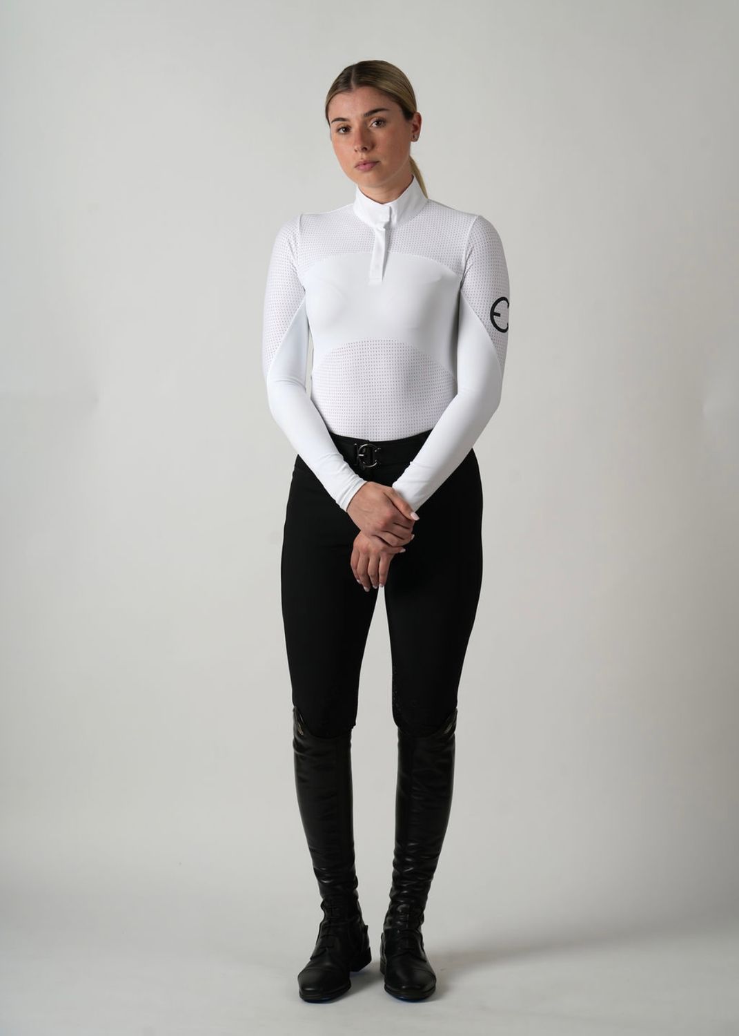 Model wearing the Ava competition top with long sleeves and perforations for better ventilation.