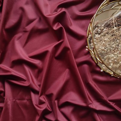 Burgundy microfiber fabric with glossy front and matte back texture

