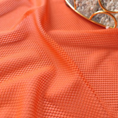 Bright orange stretch mesh with 4-way stretch


