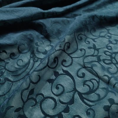 Maille extensible vert sarcelle à motif arabesque