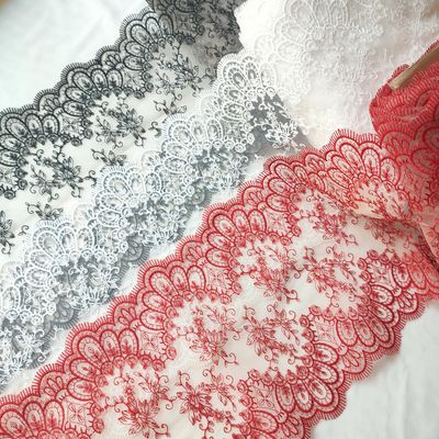Non-stretch embroidered lace in black, white, and red with scalloped edges


