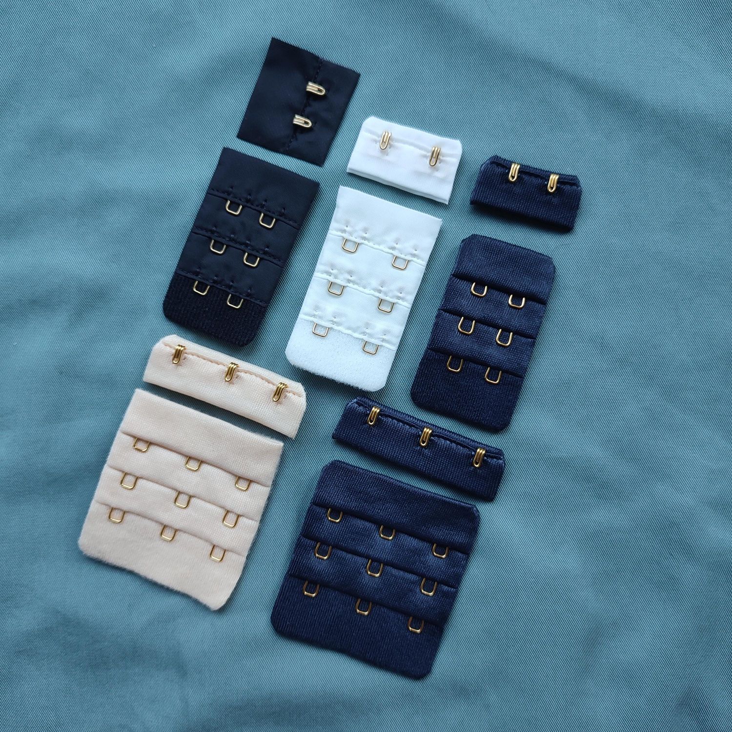 Wide bra closures with gold hooks in assorted colors