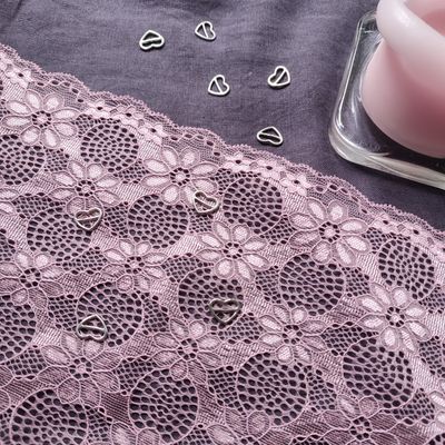 Dusty pink stretch lace with scalloped floral design

