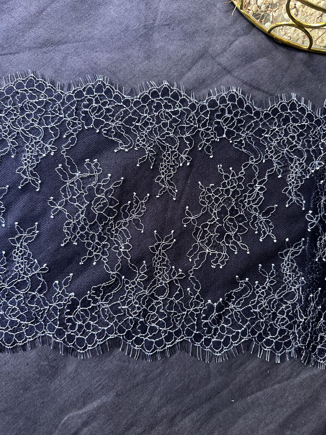 Dark navy Chantilly lace with ecru embroidery, 22 cm wide

