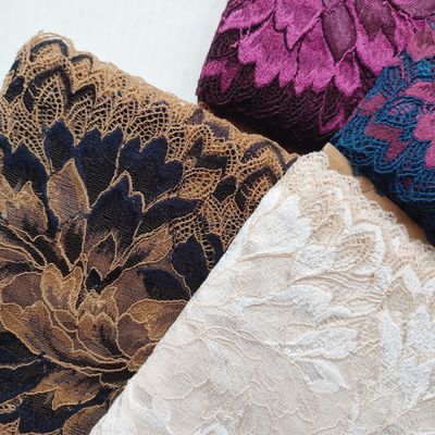 Tanned skin and blue stretch lace with floral pattern, 20 cm wide, for lingerie sewing.