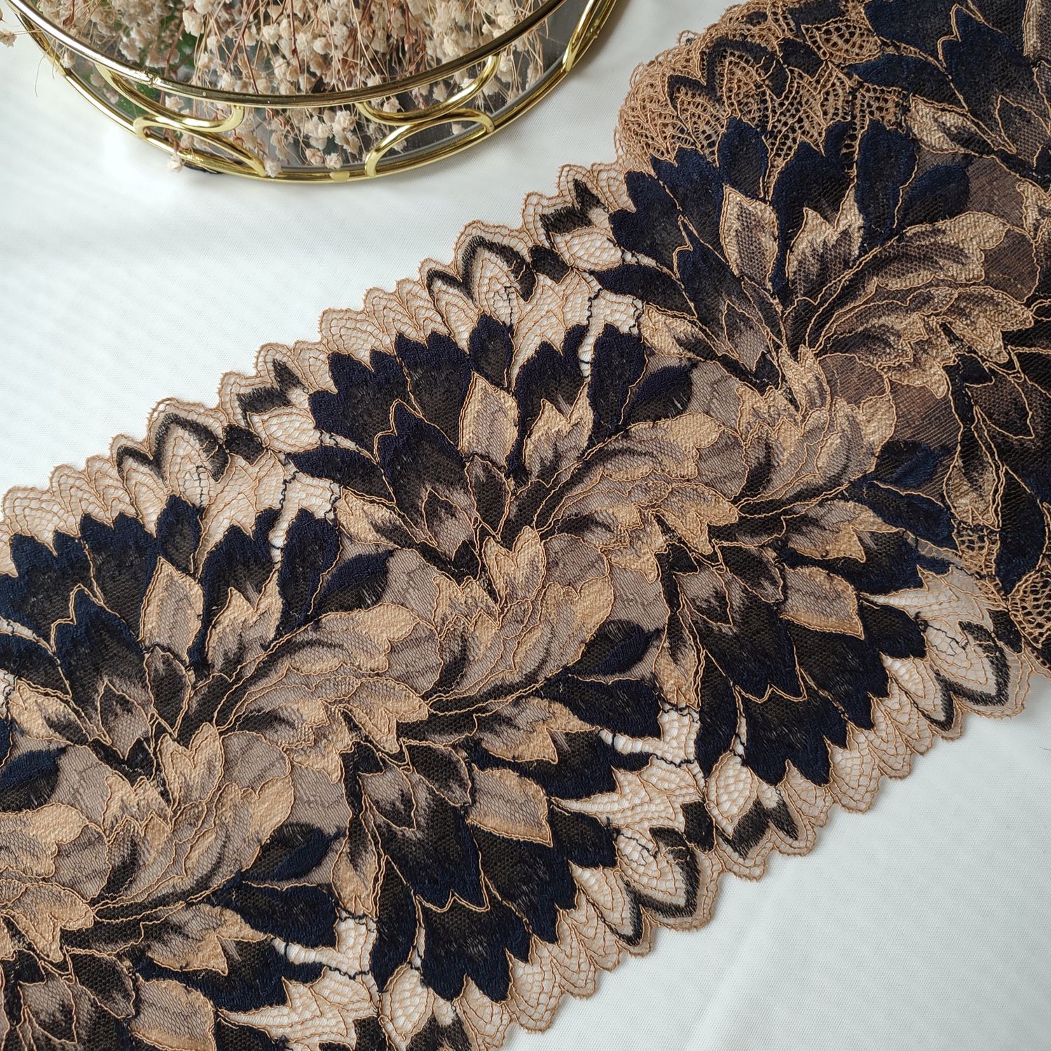Tanned skin and blue stretch lace with floral pattern, 20 cm wide, for lingerie sewing.