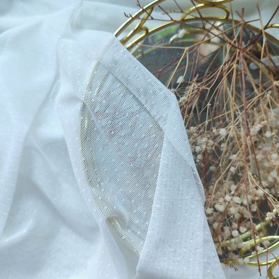 Ivory dotted stretch mesh fabric for lingerie sewing, semi-sheer soft tulle with small dots.