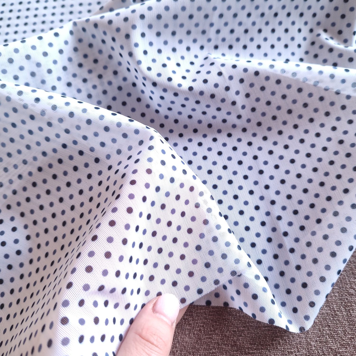 White stretch mesh with navy polka dot pattern