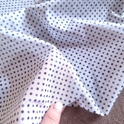 White Polka Dot Stretch Mesh White stretch mesh with navy polka dot pattern