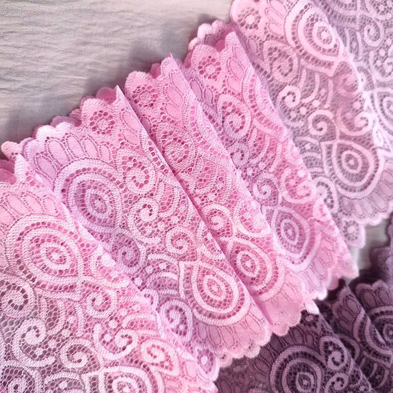 Bright pink stretch lace with paisley design and scalloped edges laid