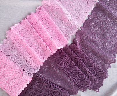 Bright pink stretch lace with paisley design and scalloped edges laid