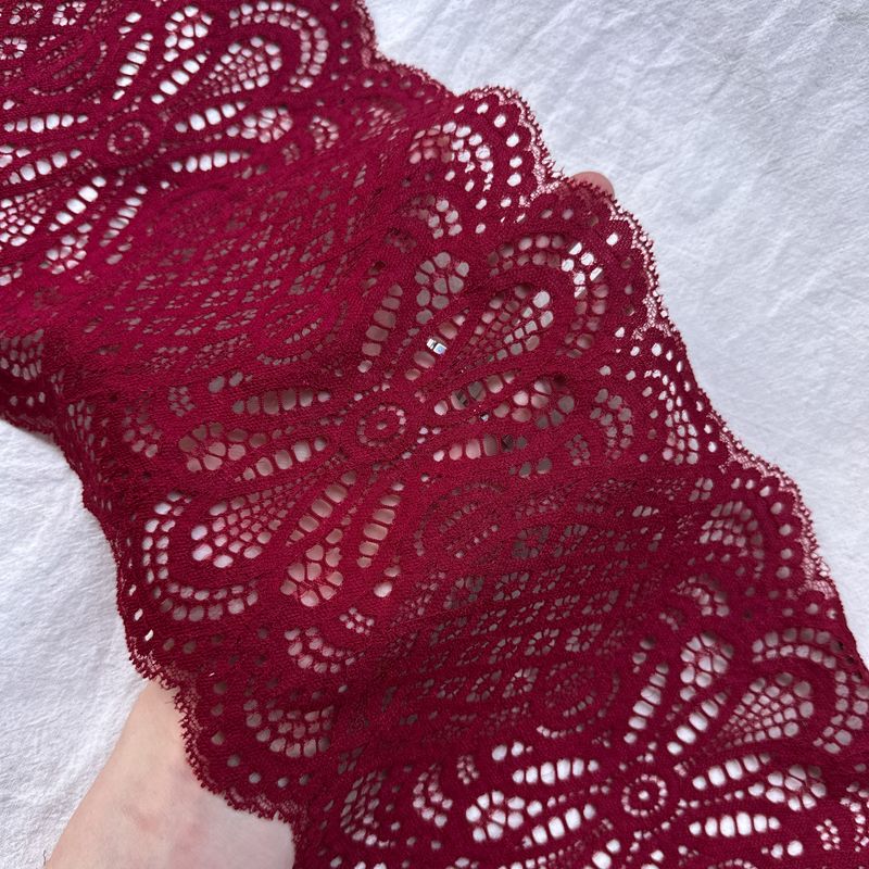 Burgundy stretch lace for sewing lingerie with bold textured pattern

