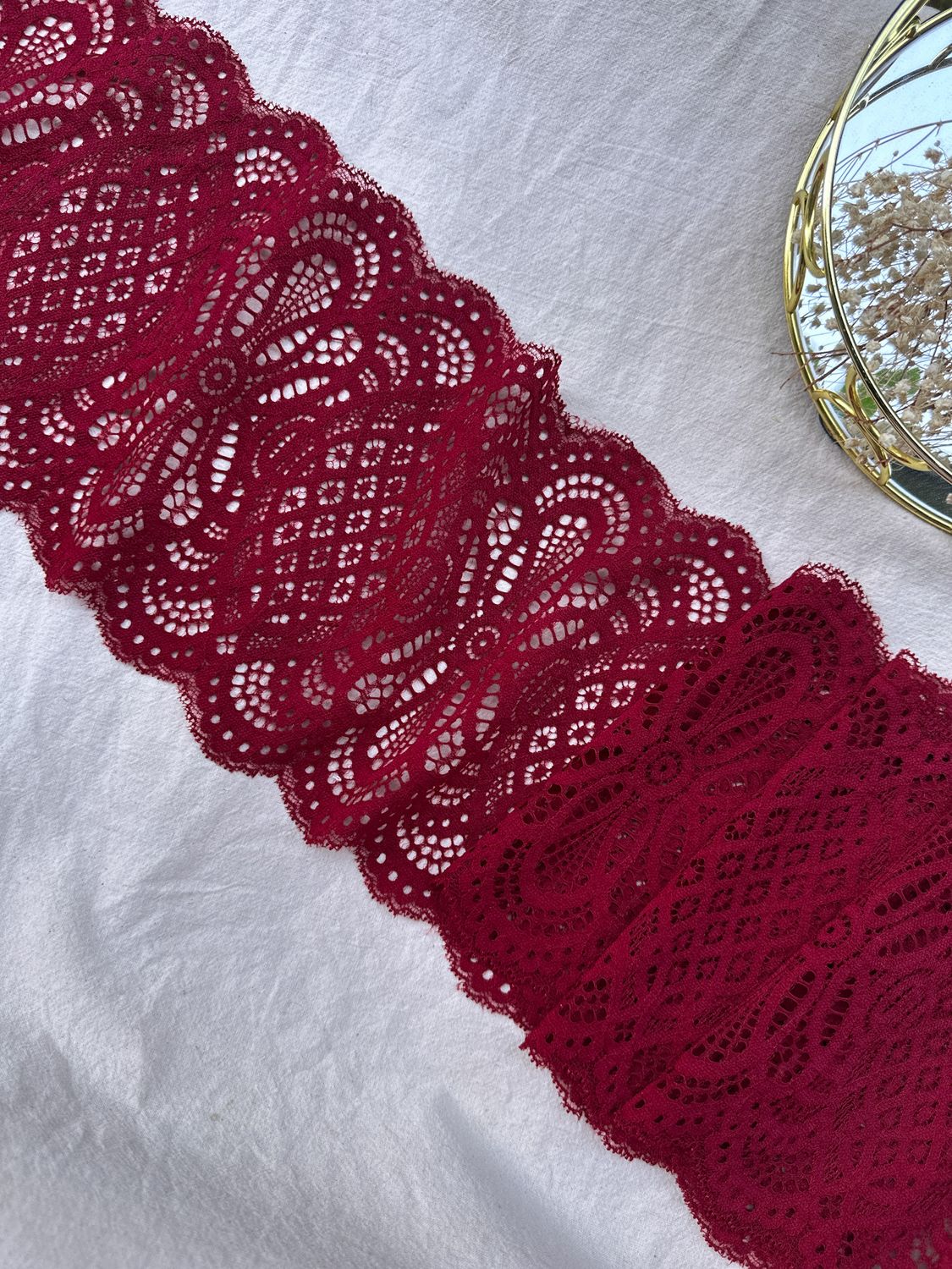 Burgundy stretch lace for sewing lingerie with bold textured pattern

