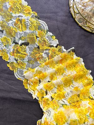 Yellow floral stretch lace on ecru base, 18 cm wide

