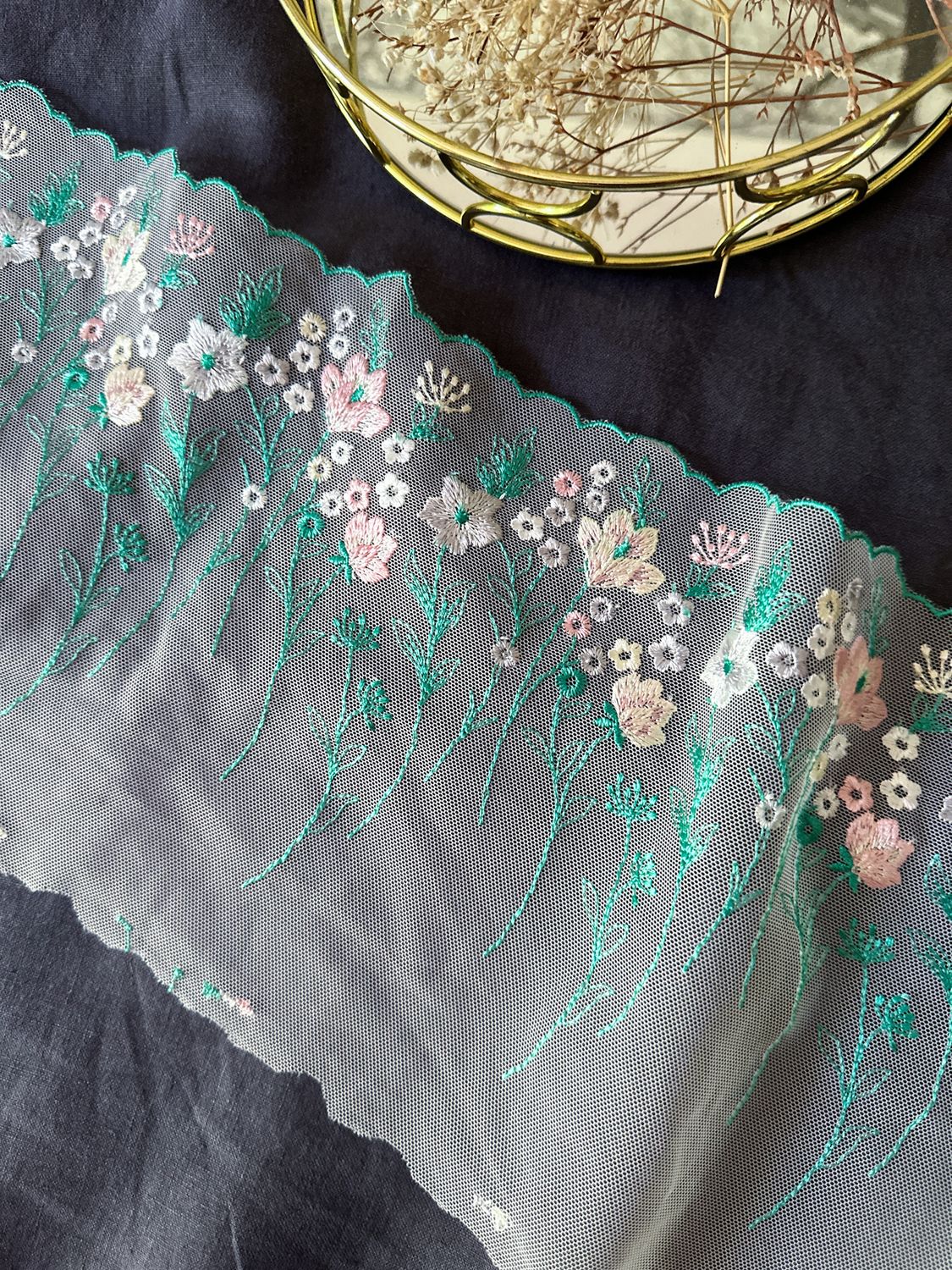 Floral embroidery lace on powder mesh with mint green leaves

