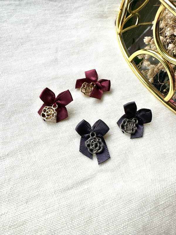 Decorative satin bow with charm