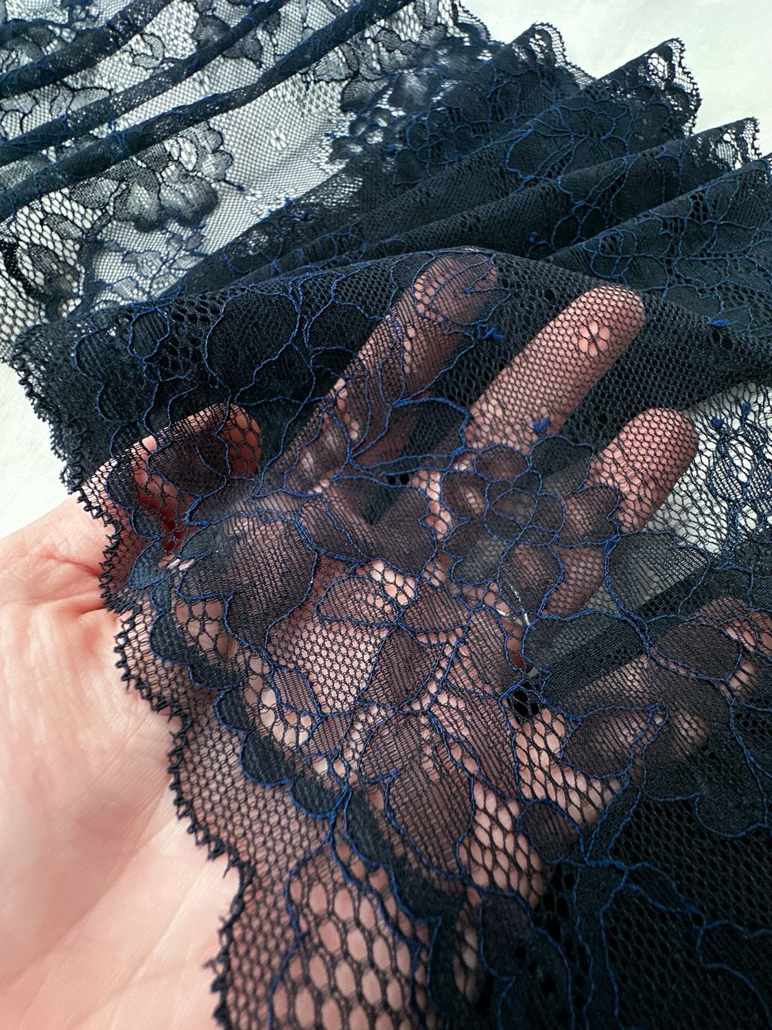 Black lace with blue thread for bra making
