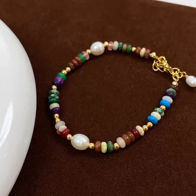 Pulsera acero y piedras chapada en Oro de 18 k