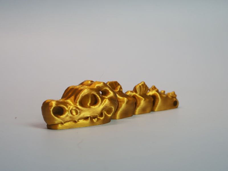 Czaszka dinozaura - brelok - złoty