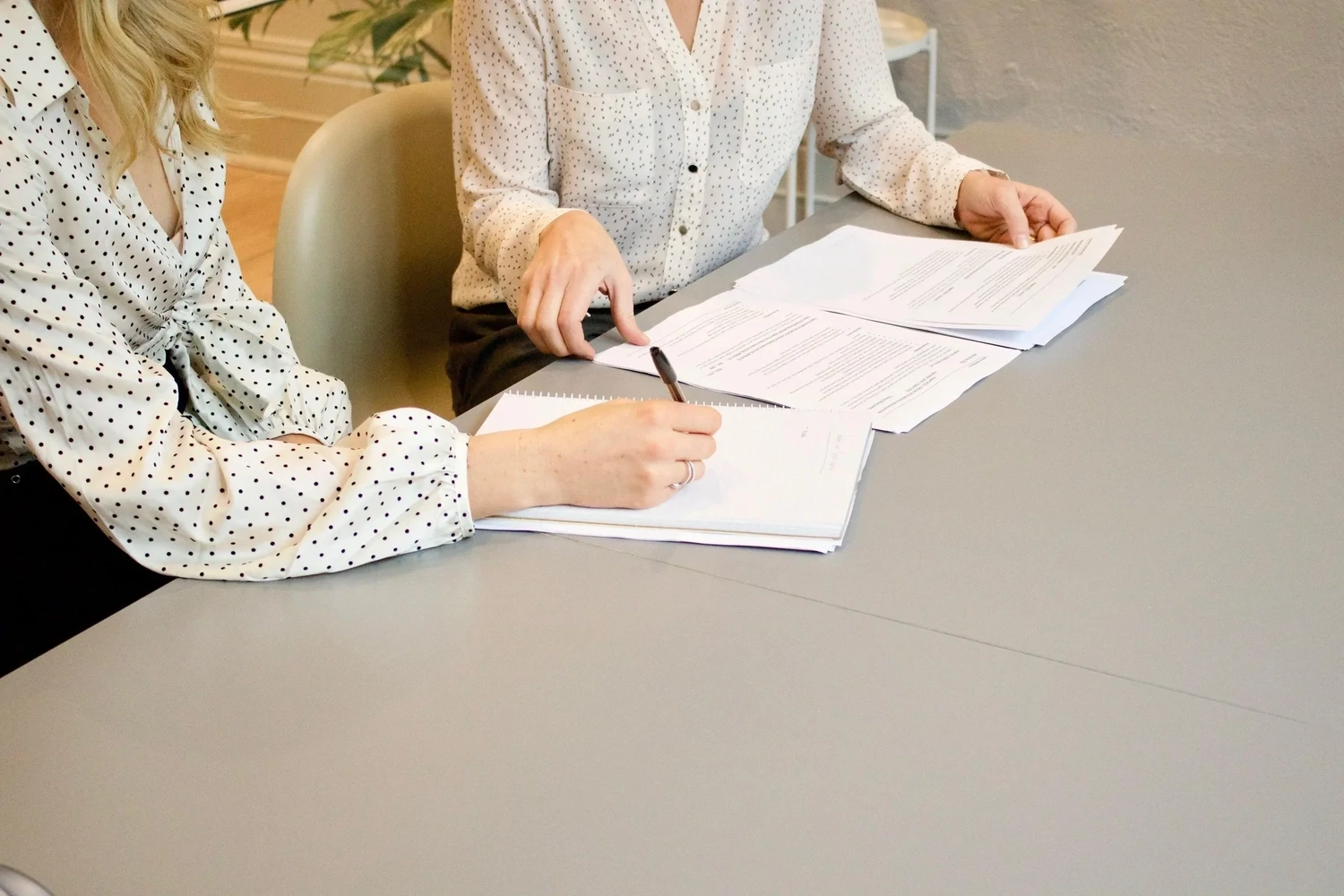 Solicitor at a desk reviewing a pre-sue report to show the Pre-sue and pre-litigation asset reporting service