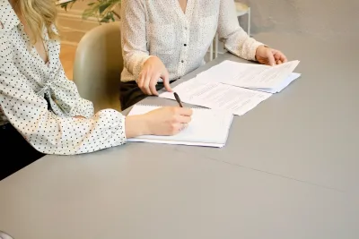 Solicitor at a desk reviewing a pre-sue report to show the Pre-sue and pre-litigation asset reporting service