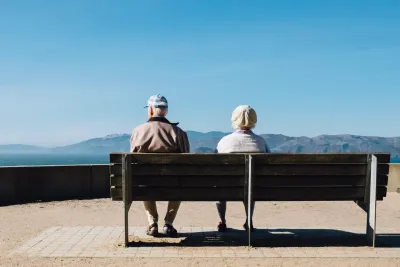 Two pensioners sitting on a bench with amazing Mountain View to show the Pension member tracing service