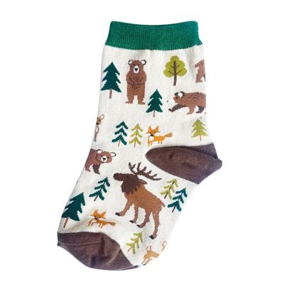 White child's sock, featuring woodland animals such as moose, bears, foxes, and various trees.  Green and brown accents.