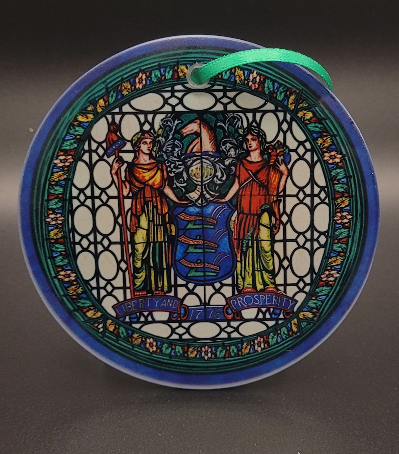 A stained glass ornament featuring the Great Seal of New Jersey from the New Jersey State House