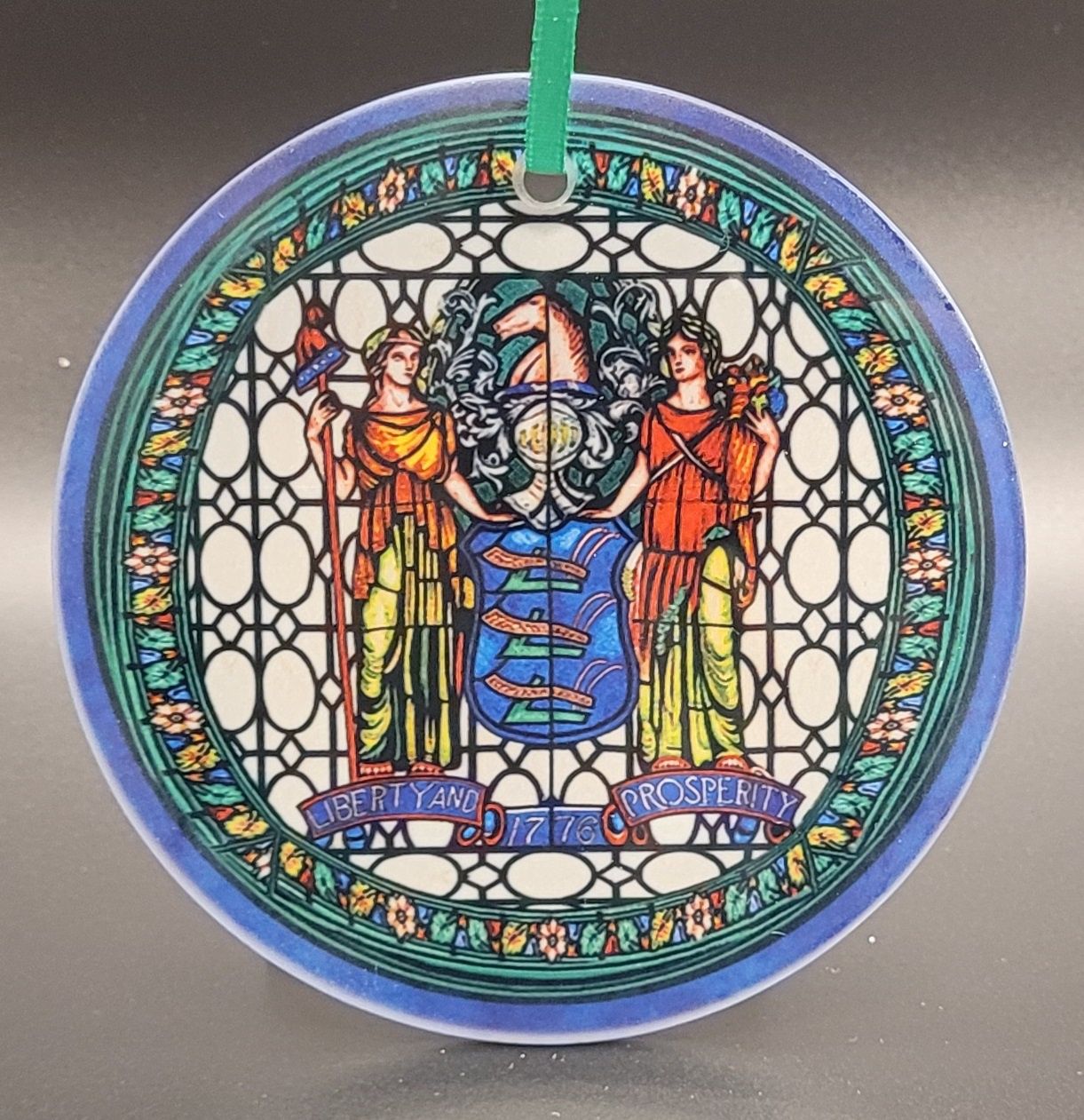 A stained glass ornament featuring the Great Seal of New Jersey from the New Jersey State House
